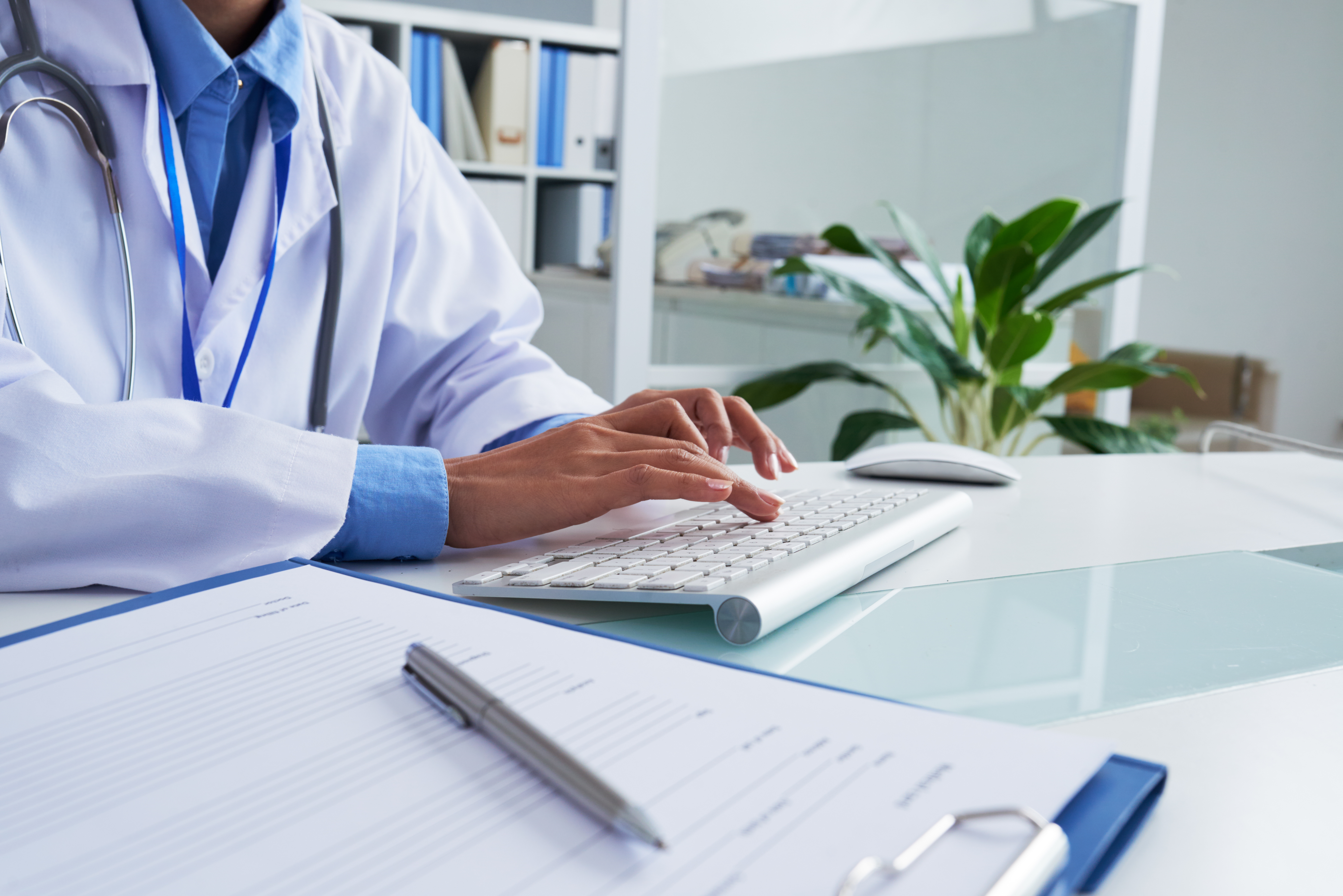 Hands of female doctor typing on keyboard Hands of female doctor typing on keyboard